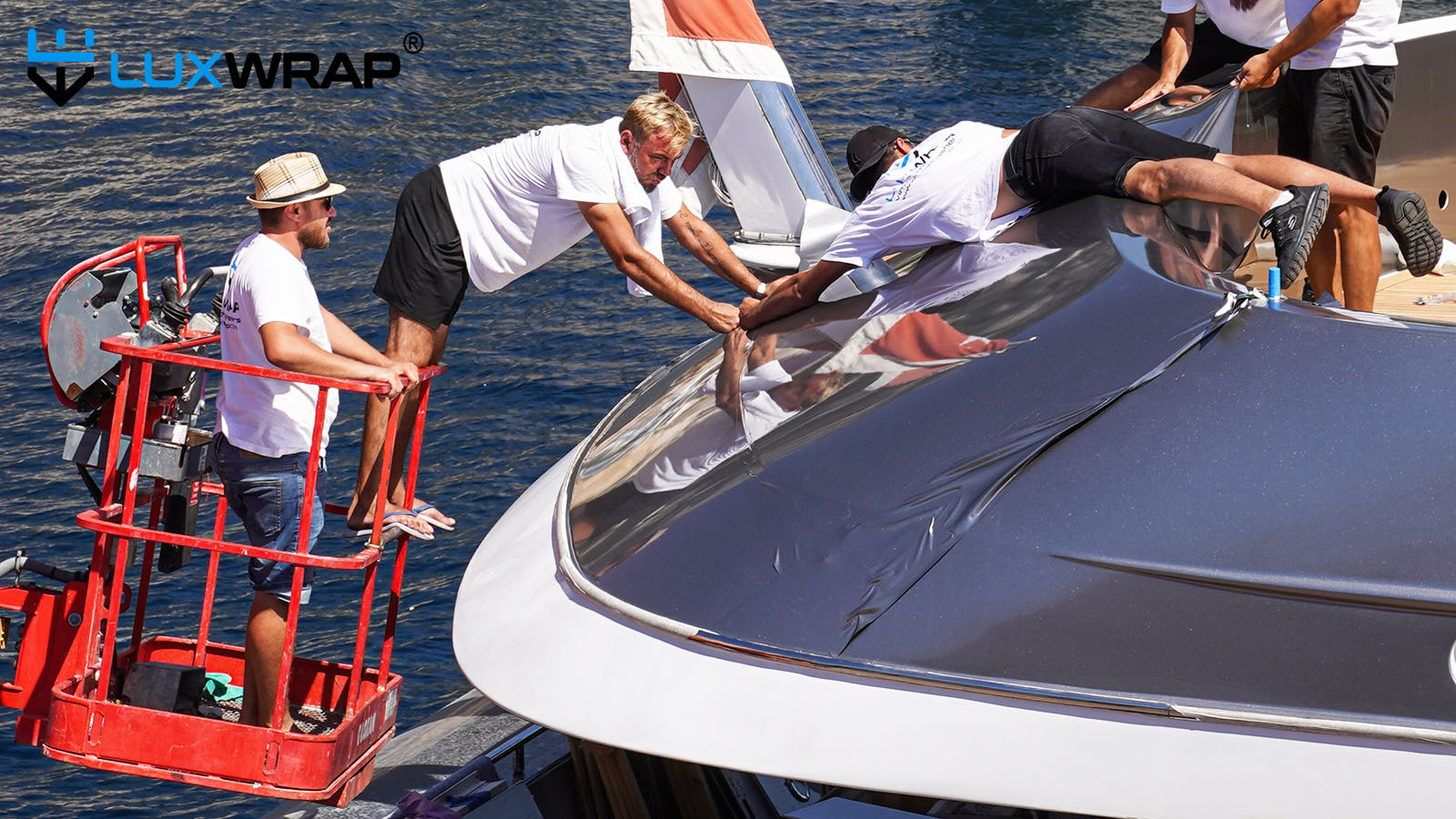 Superman helps wrap yacht superstructure with cherry picker support