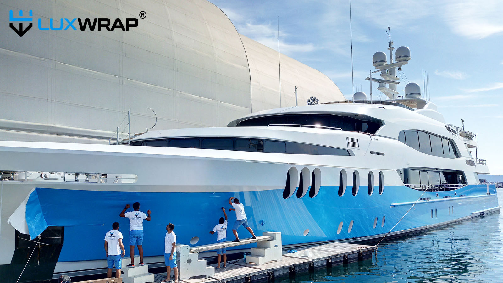 Team admires 60 meter yacht wrapped in the water
