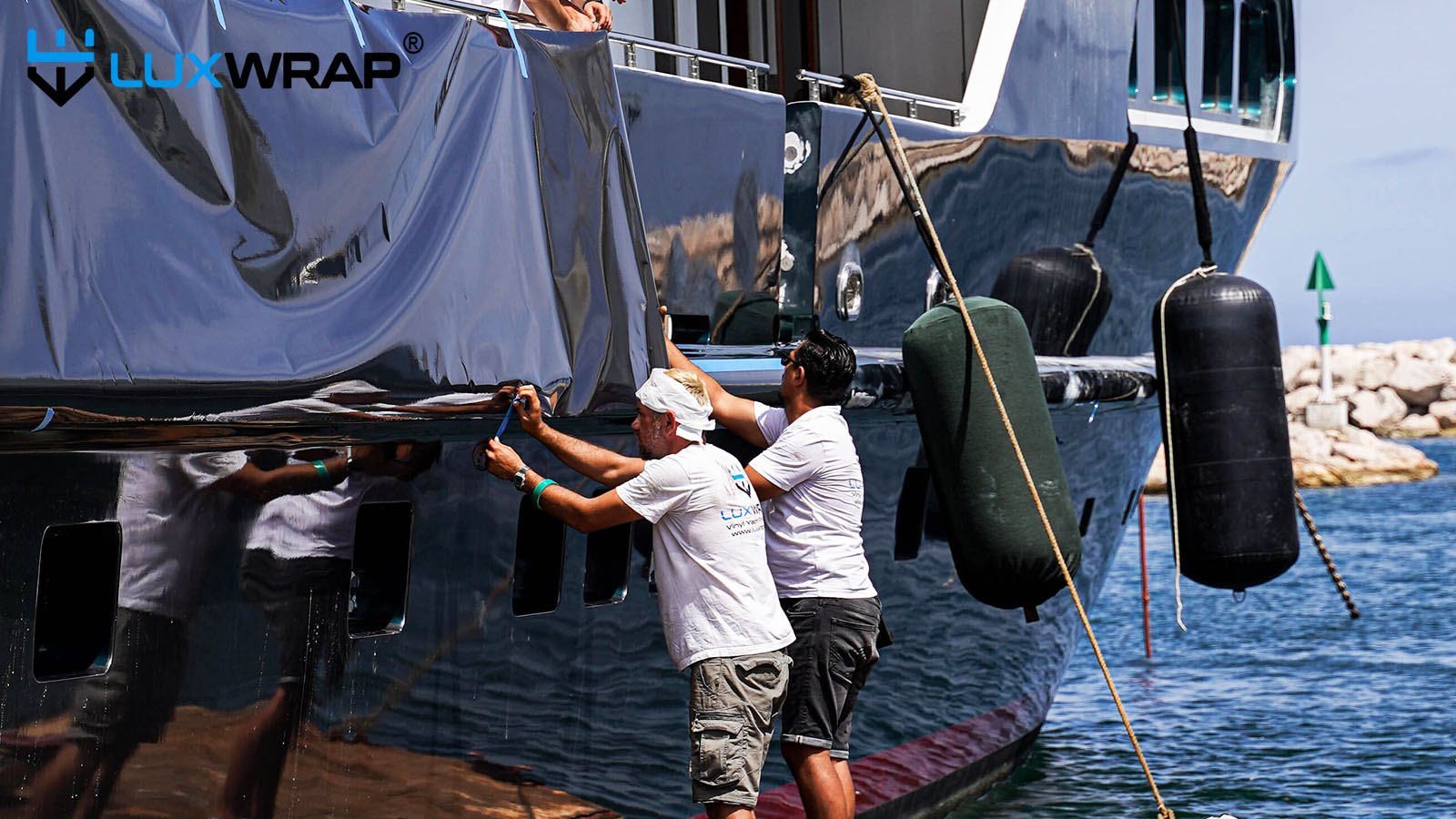 Superyacht is wrapped from floating rafts by expert installers from LuxWrap