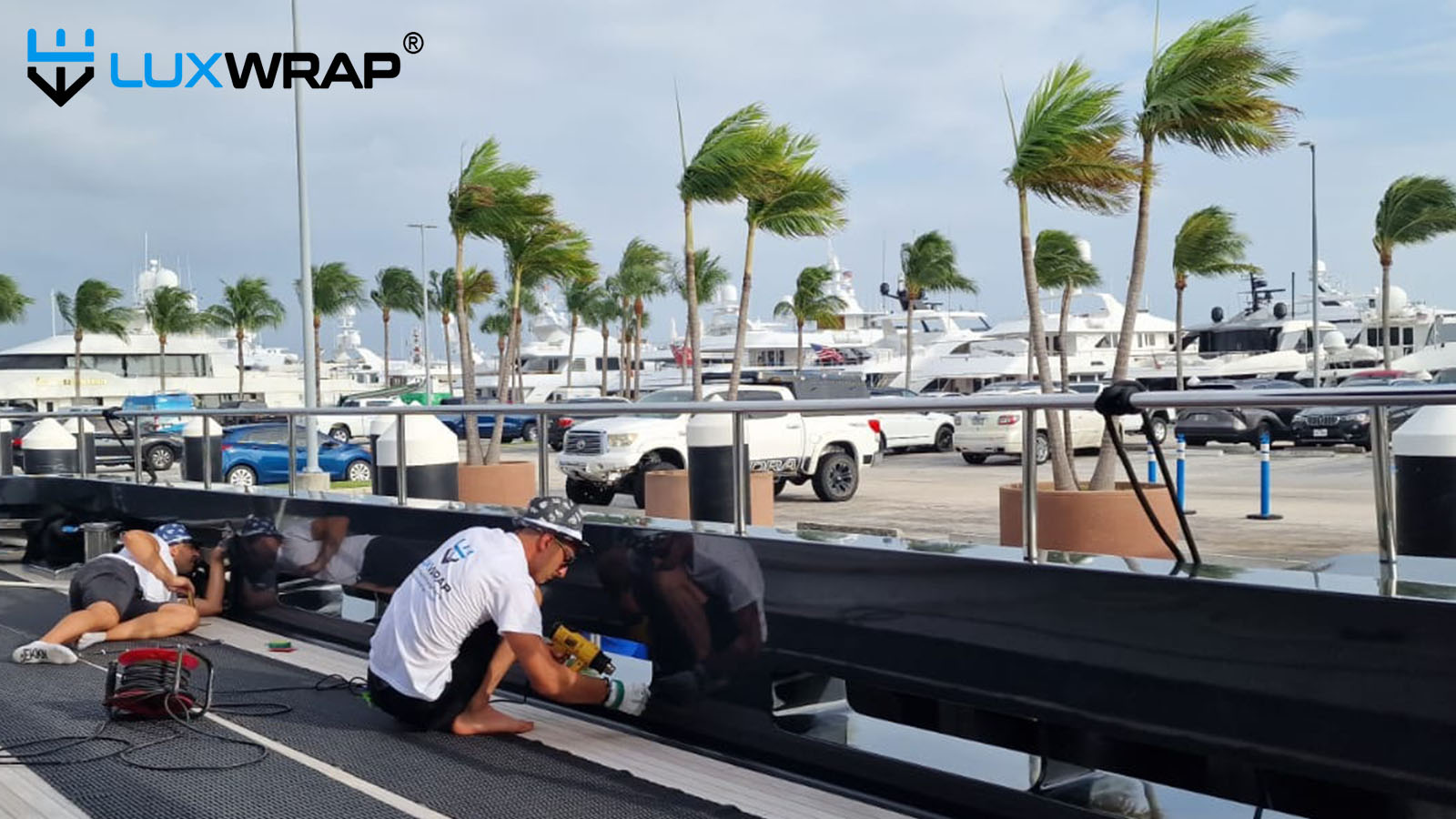 Harness access to wrap difficult to reach areas of yacht hull.