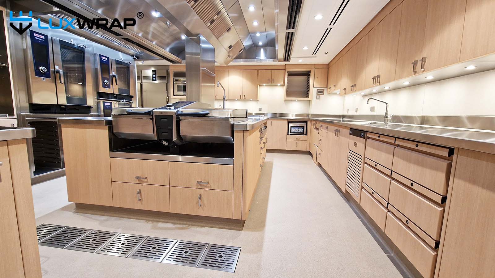 New-build mega yacht galley wrapped with wood grain architectural film
