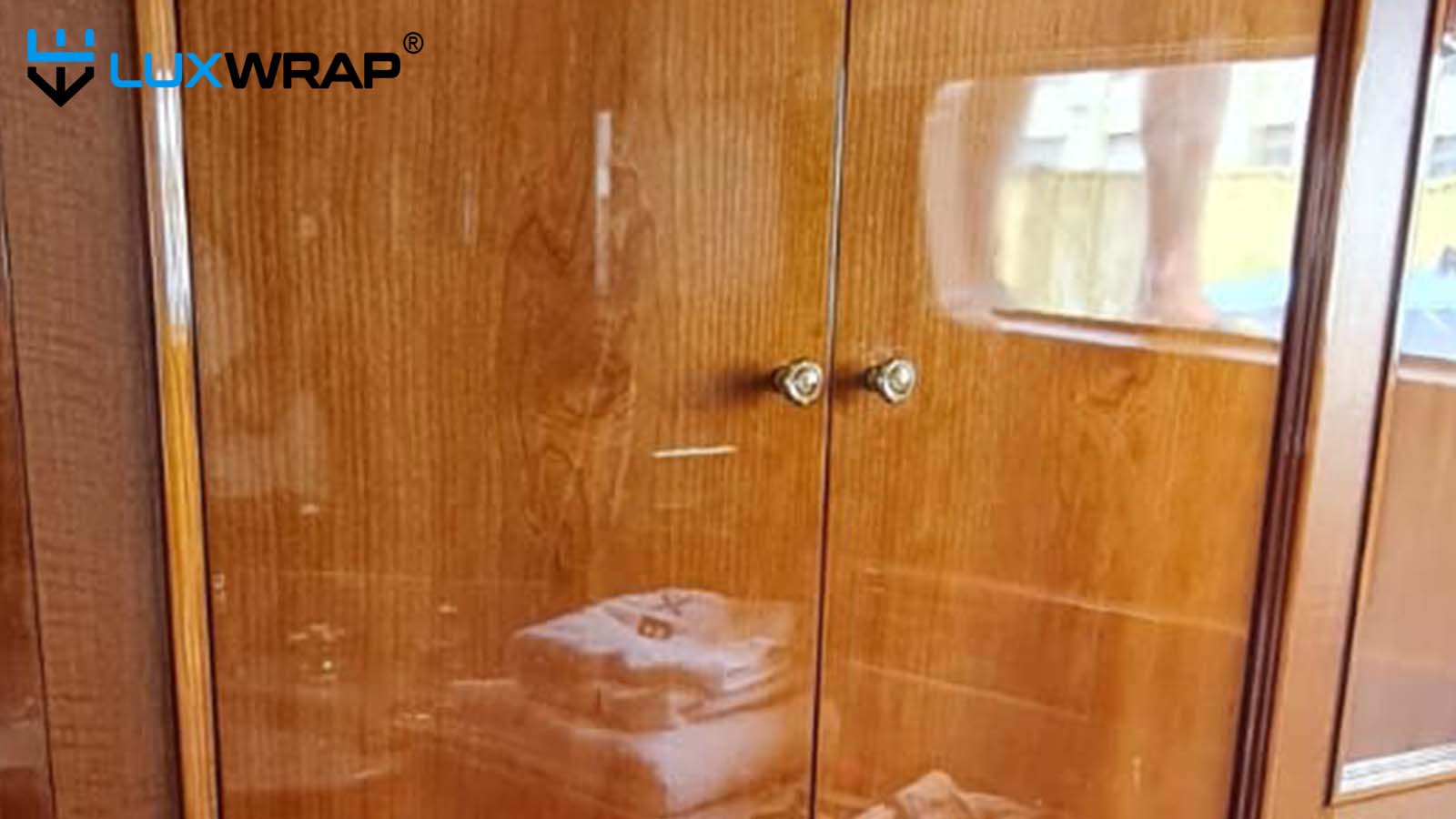 Refinishing yacht gloss wood interior with vinyl and NinjaShield PPF to match real exisiting varnished wood finishes.