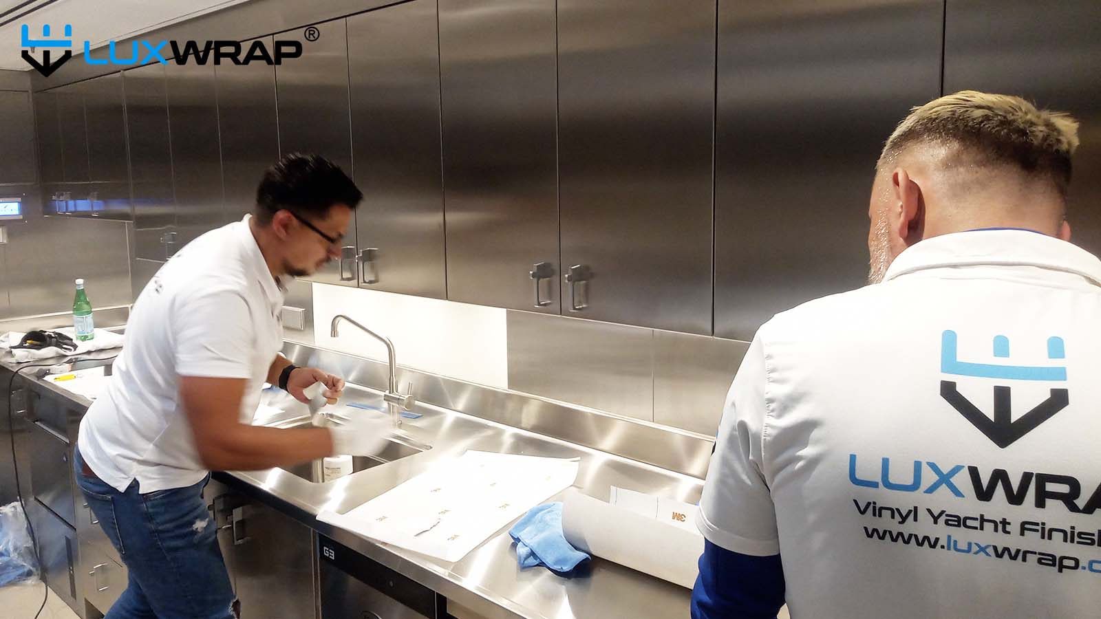 New-build mega yacht galley wrapped with wood grain architectural film