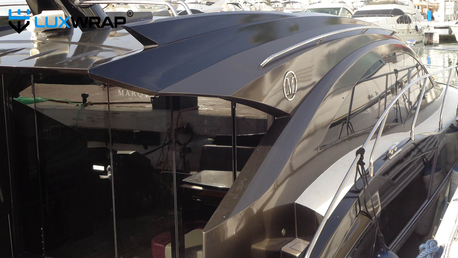 Harness access to wrap difficult to reach areas of yacht hull.