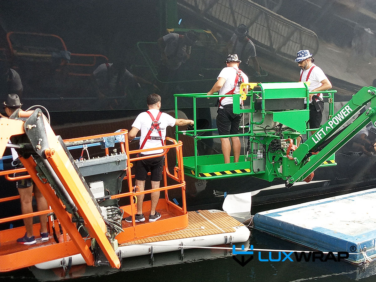 Scaffolding and access equipment arranged at a shipyard for a superyacht wrapping project