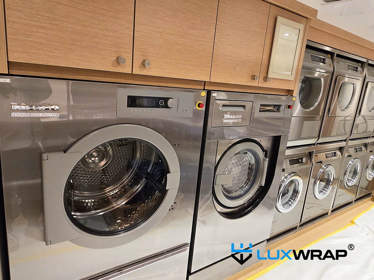 Superyacht laundry machines and stainless steel cabinetry protected with clear surface protection film