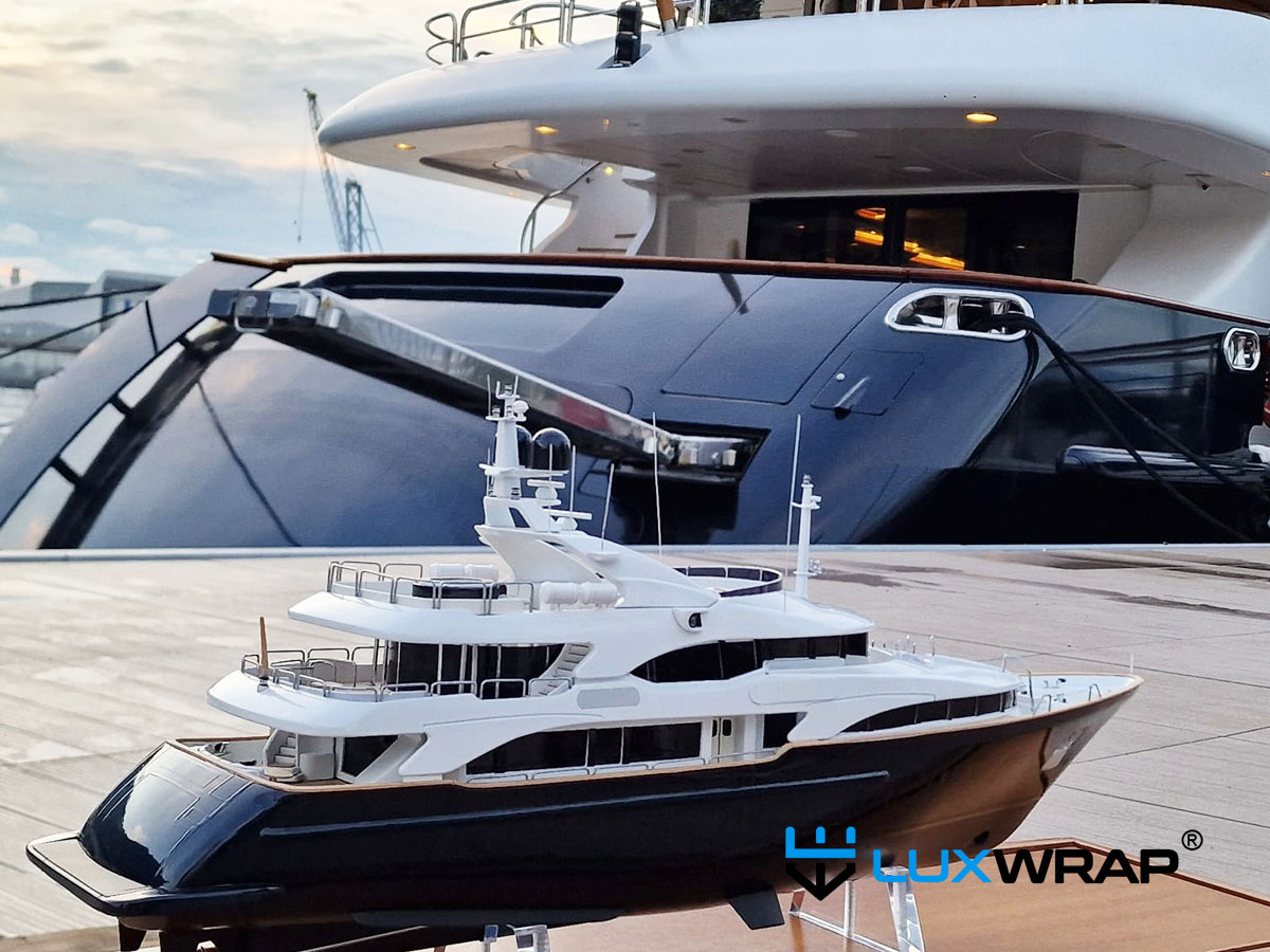 LuxWrap wrapping a miniature superyacht model to precisely match the full-size vessel wrap